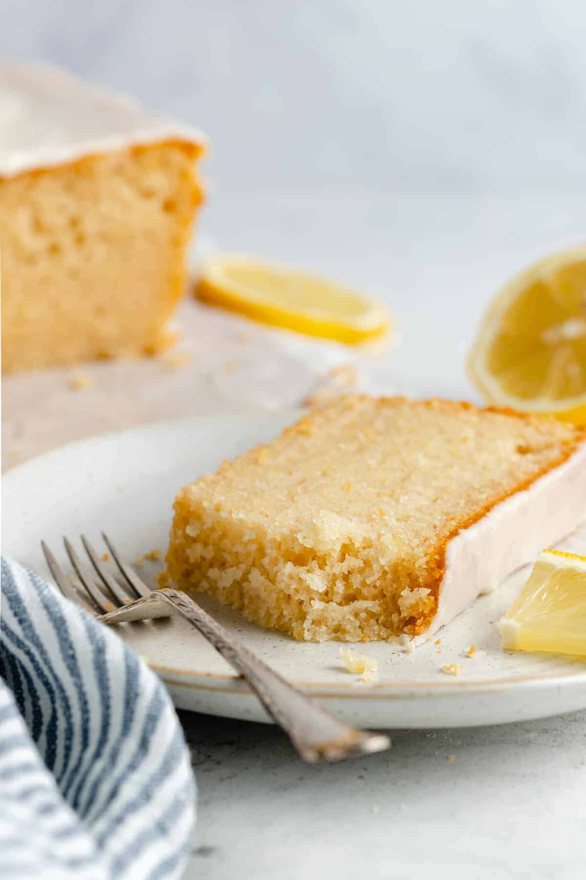 A slice of vegan lemon loaf with a fork. - 8