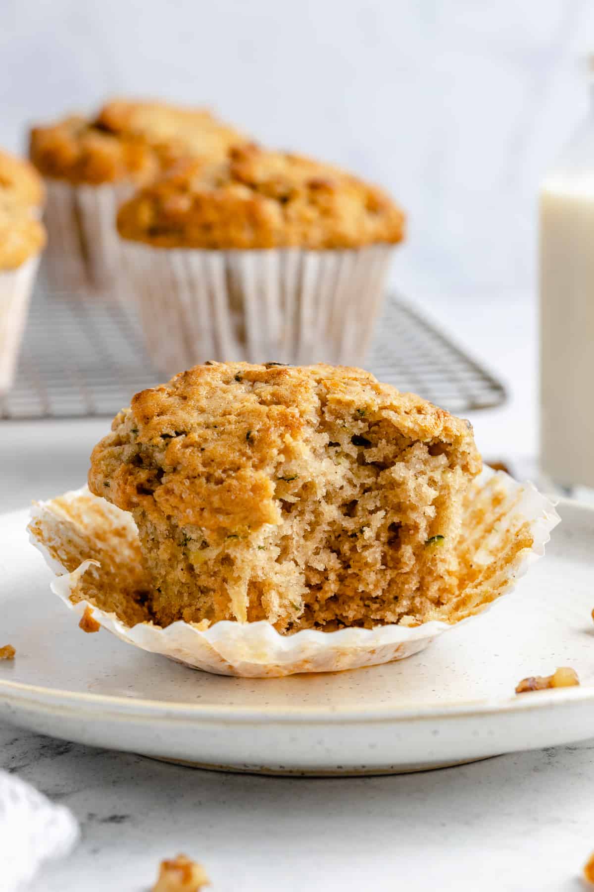 Zucchini muffin with a bite taken out of it.