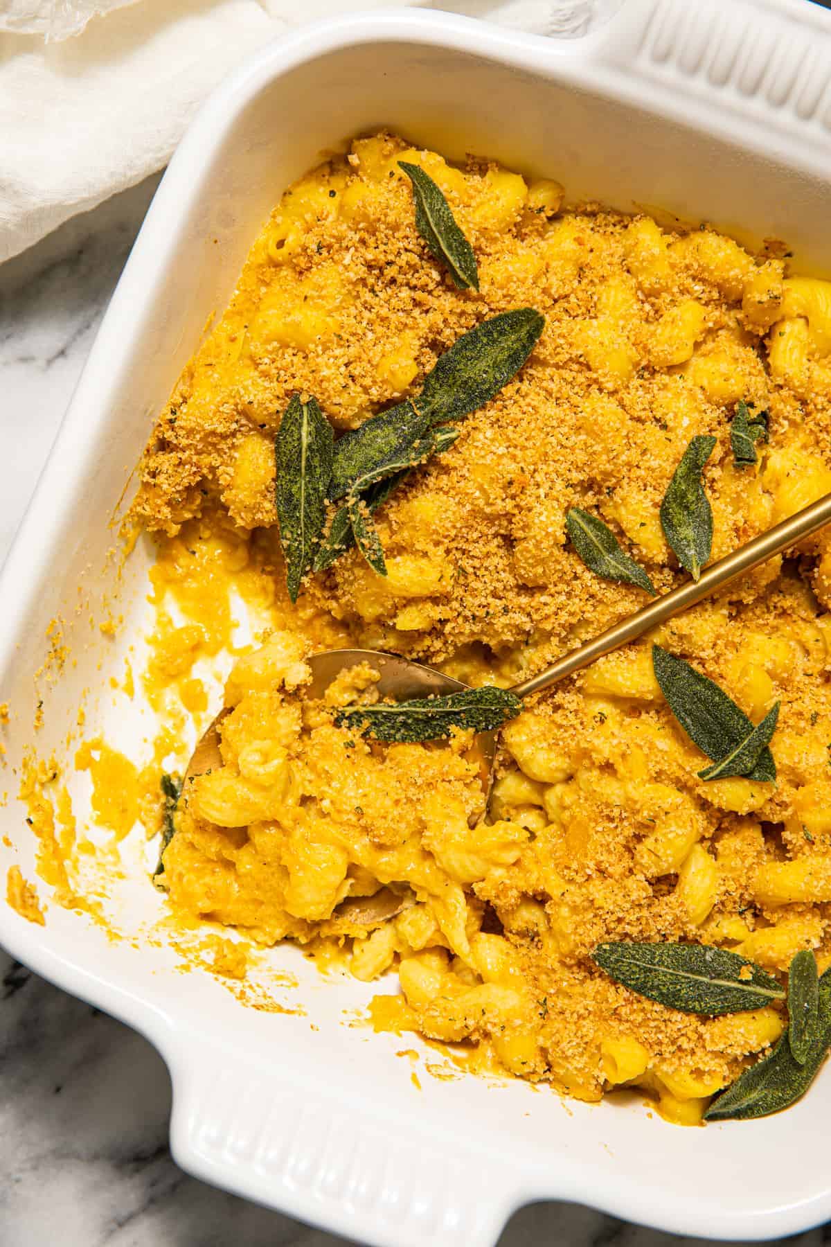 Butternut squash mac and cheese with sage leaves.
