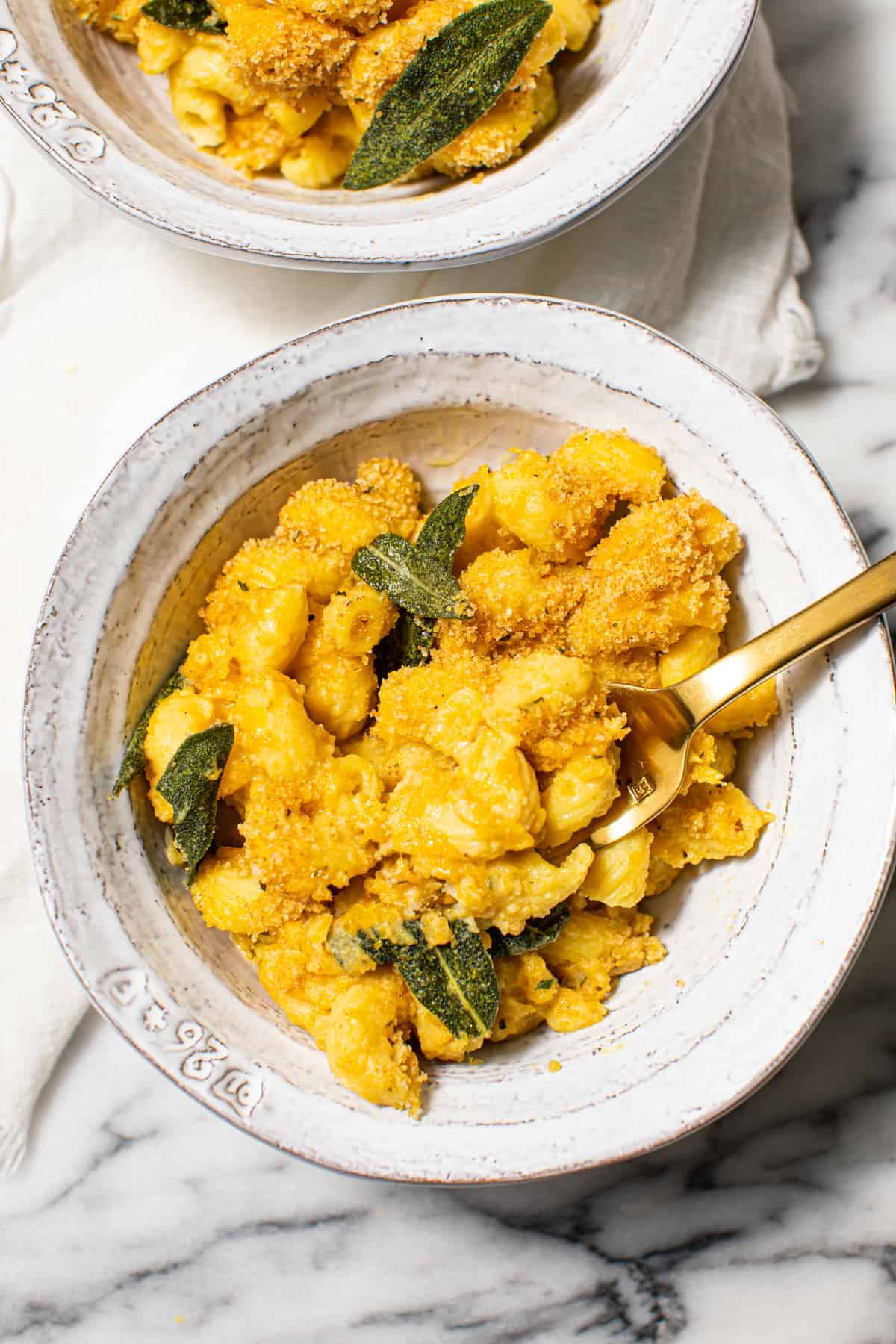 Bowl of squash macaroni and cheese with sage.