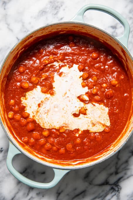 Coconut milk mixed in with chickpeas and tomato sauce.