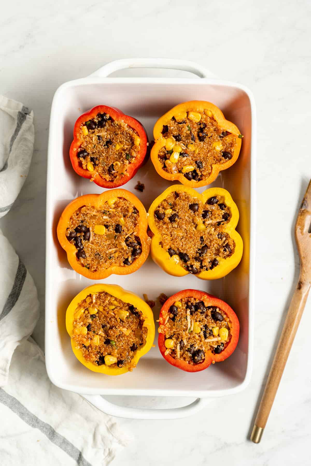 Stuffed bell peppers in a baking dish.