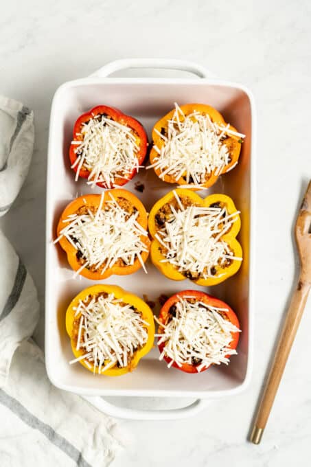 Stuffed bell peppers topped with vegan mozzarella.