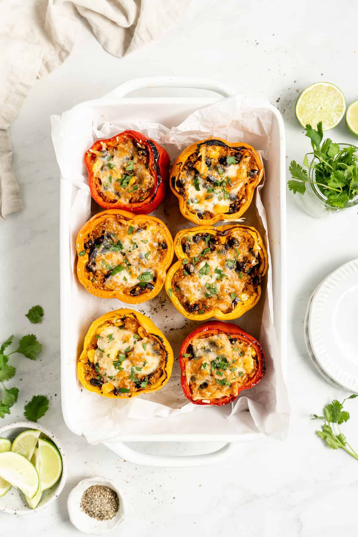 6 vegan stuffed peppers in a pan.