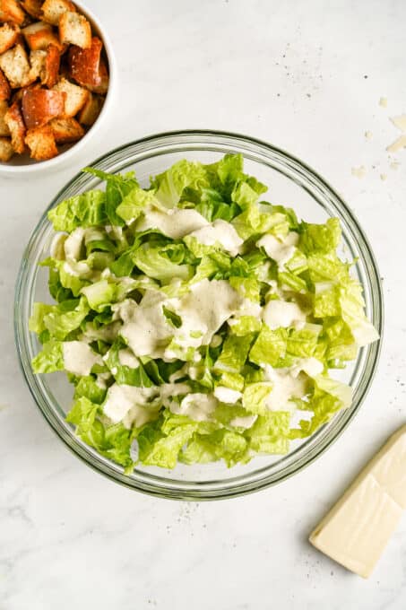 Chopped romaine lettuce with caesar salad dressing.