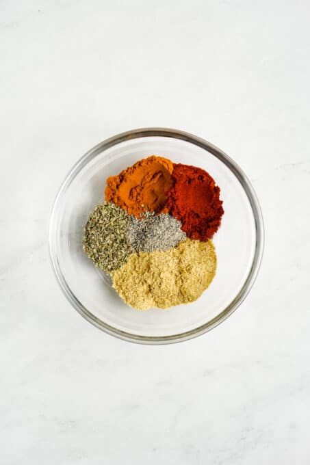 Spices and seasonings in a glass bowl.