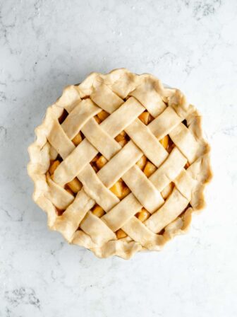 Pie crust filled with apples and covered with a lattice.