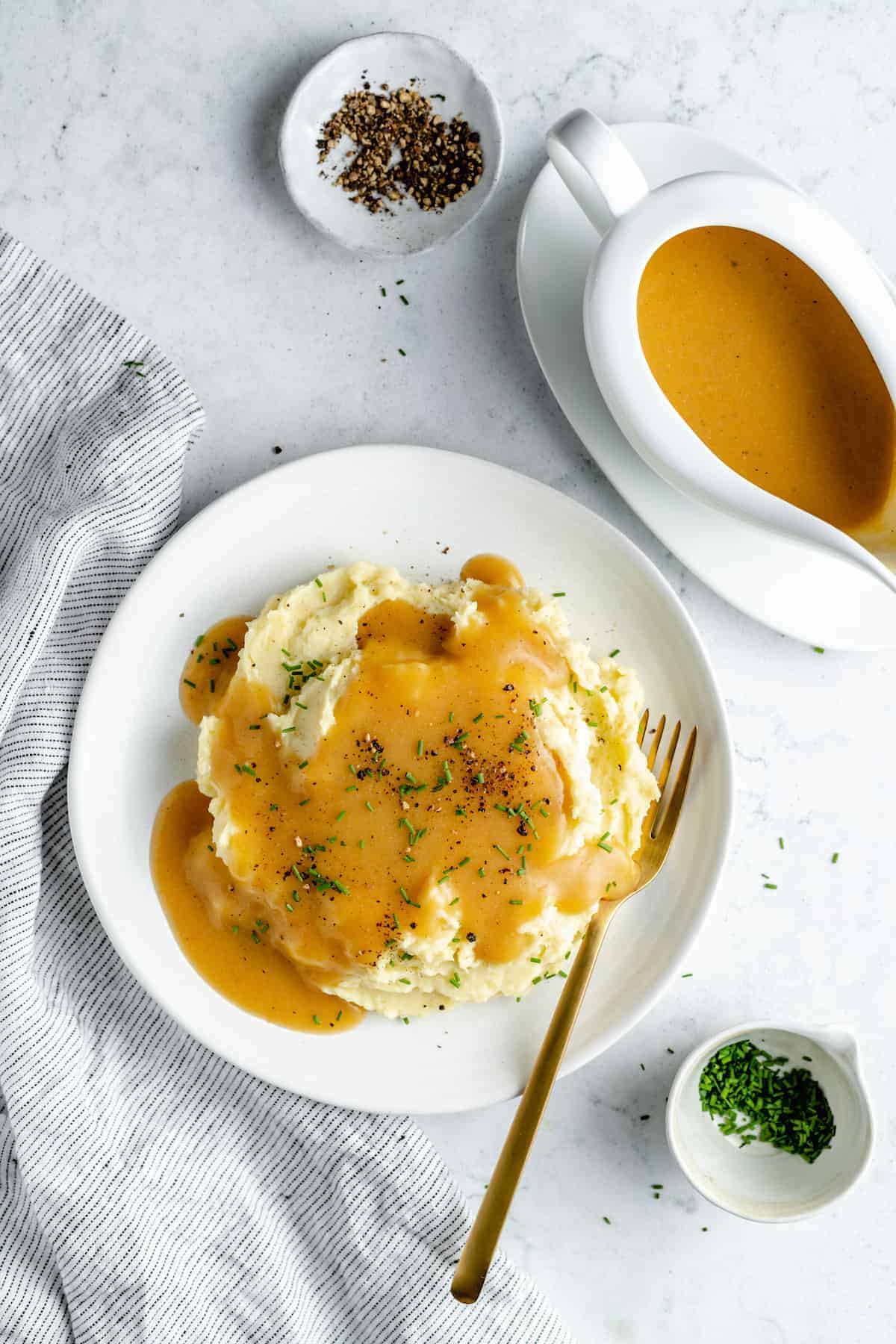 Overhead shot of mashed potatoes on plate with gravy