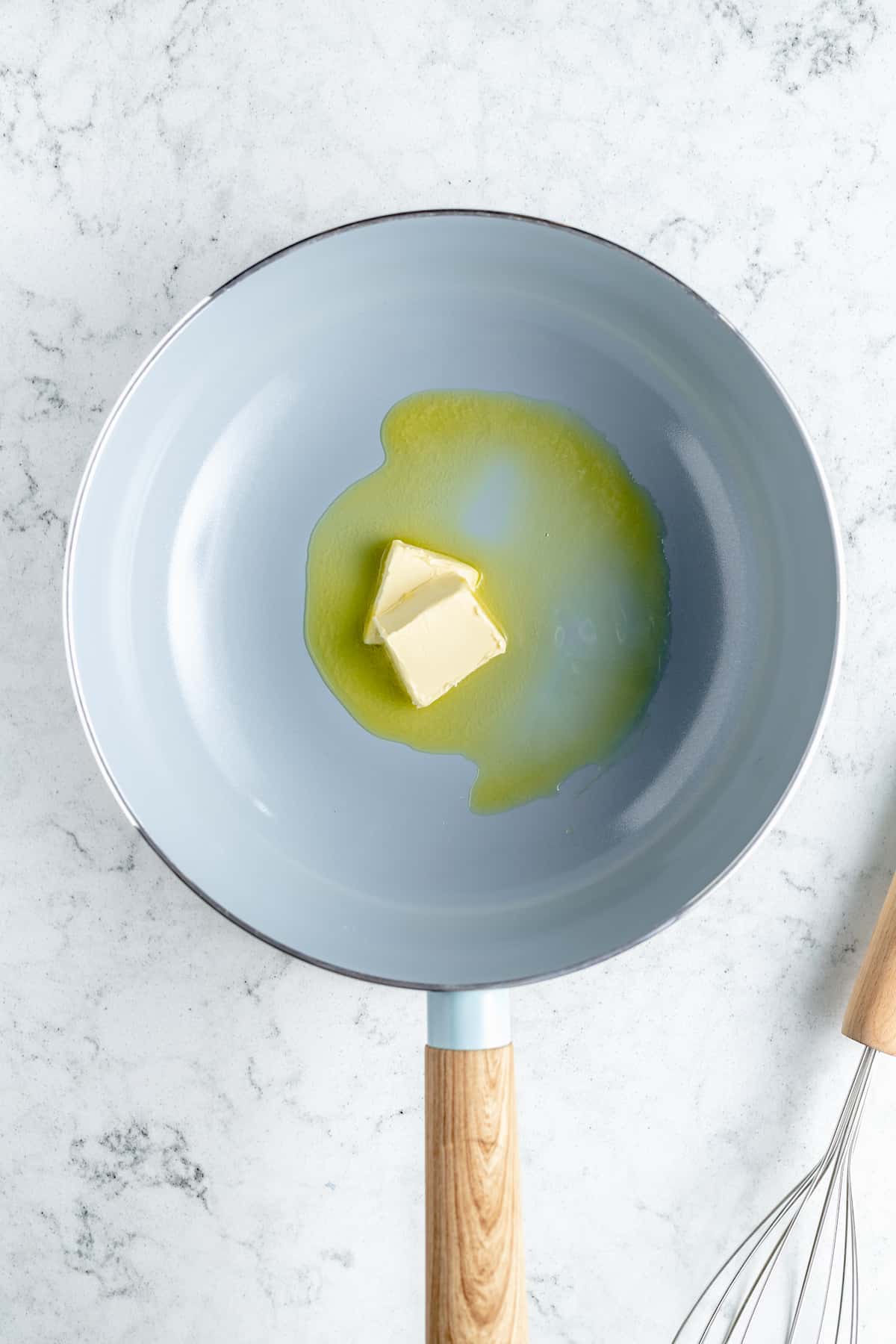 Overhead shot of butter being melted in saucepan