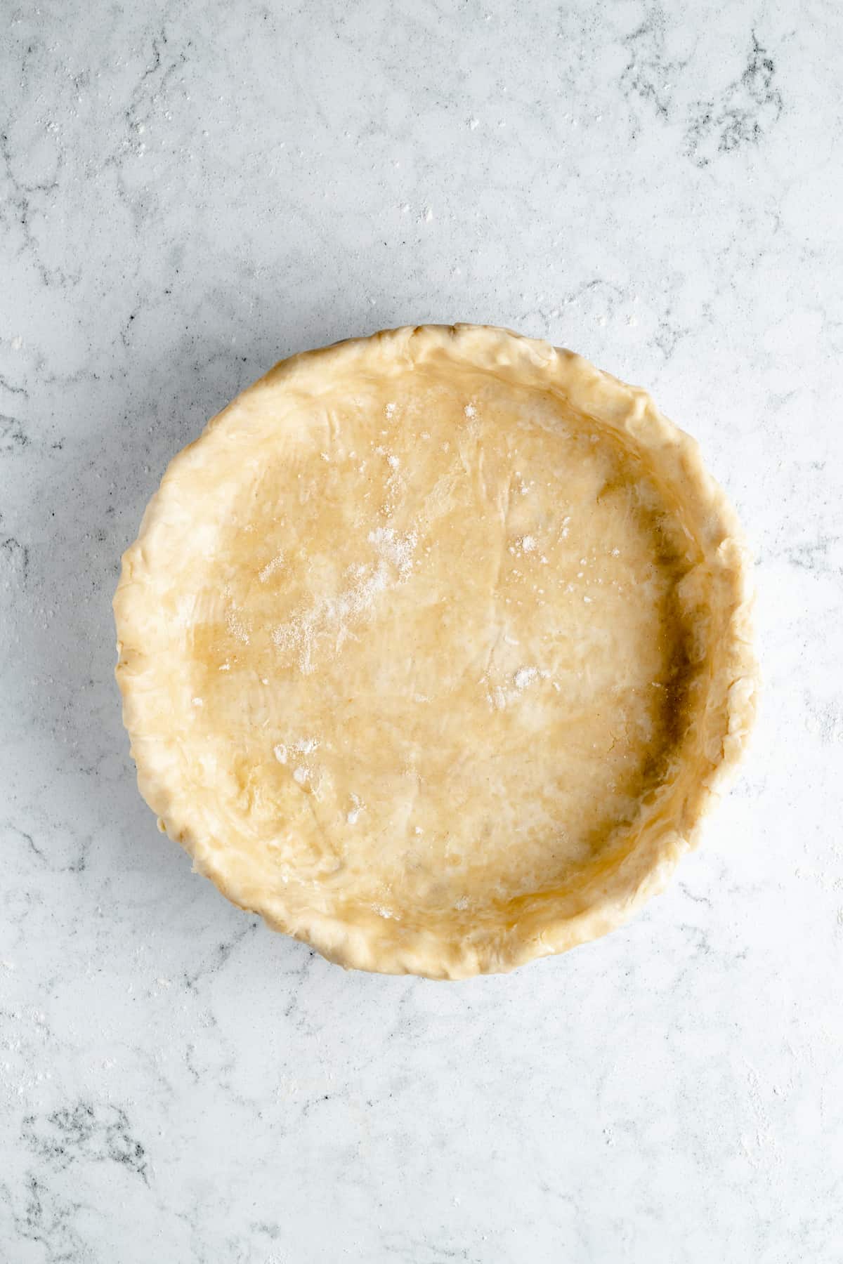 Vegan pie crust in a baking dish.