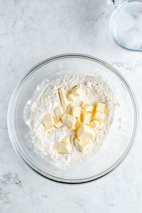 Flour with cubes of butter in a bowl.