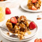 Overnight French Toast Casserole on plate with fresh strawberries