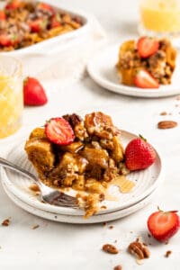 Overnight French Toast Casserole on plate with fresh strawberries