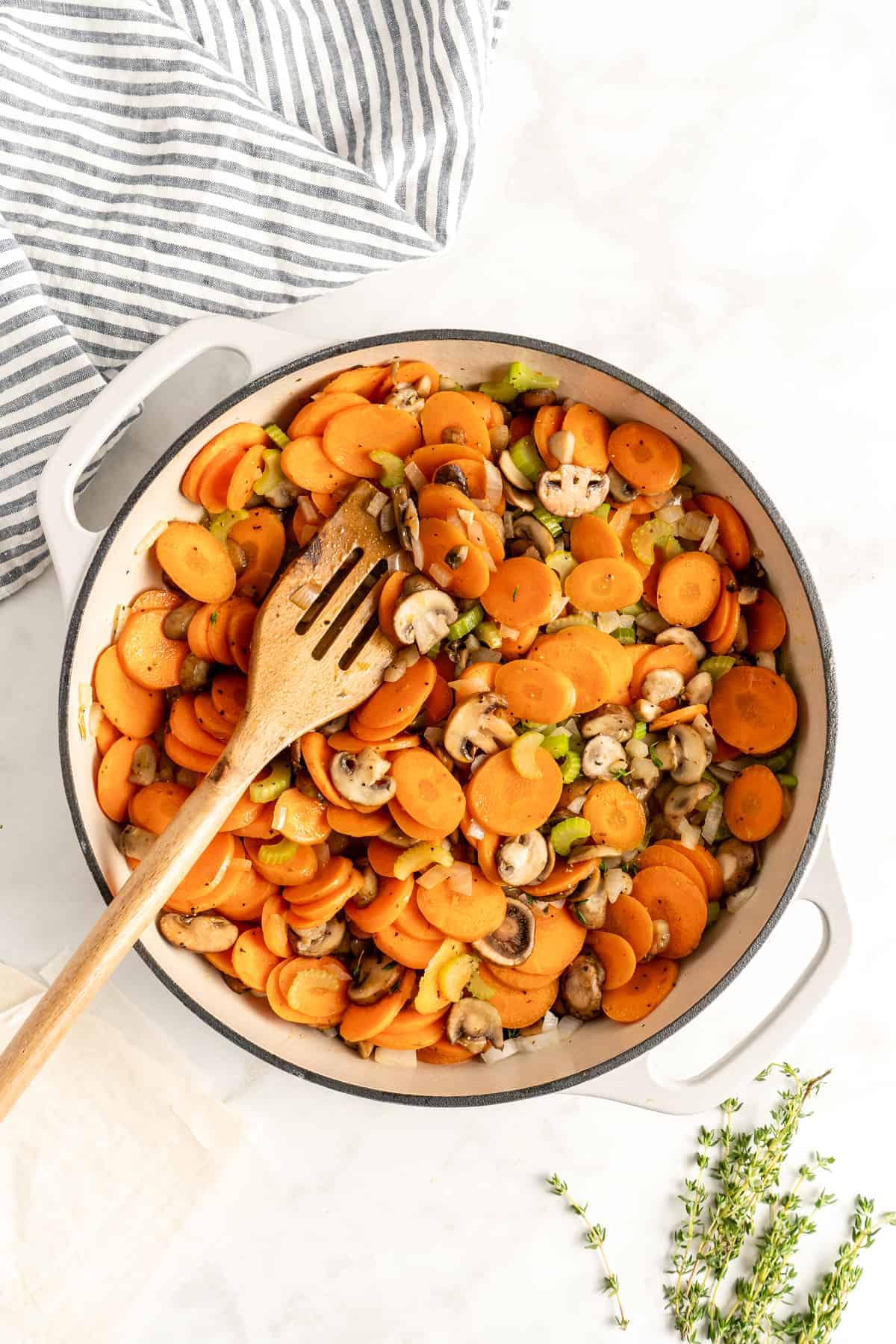 Carrots, mushrooms and other veggies in a dutch oven pot