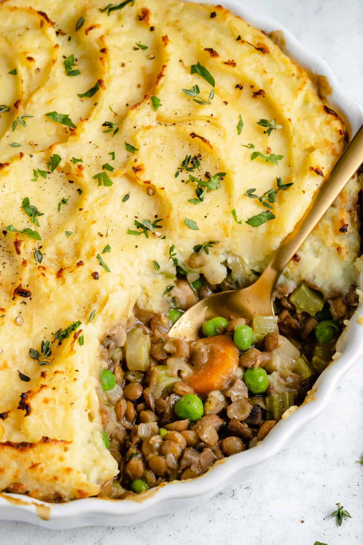 Shepherd's Pie in serving dish with a portion removed to show filling