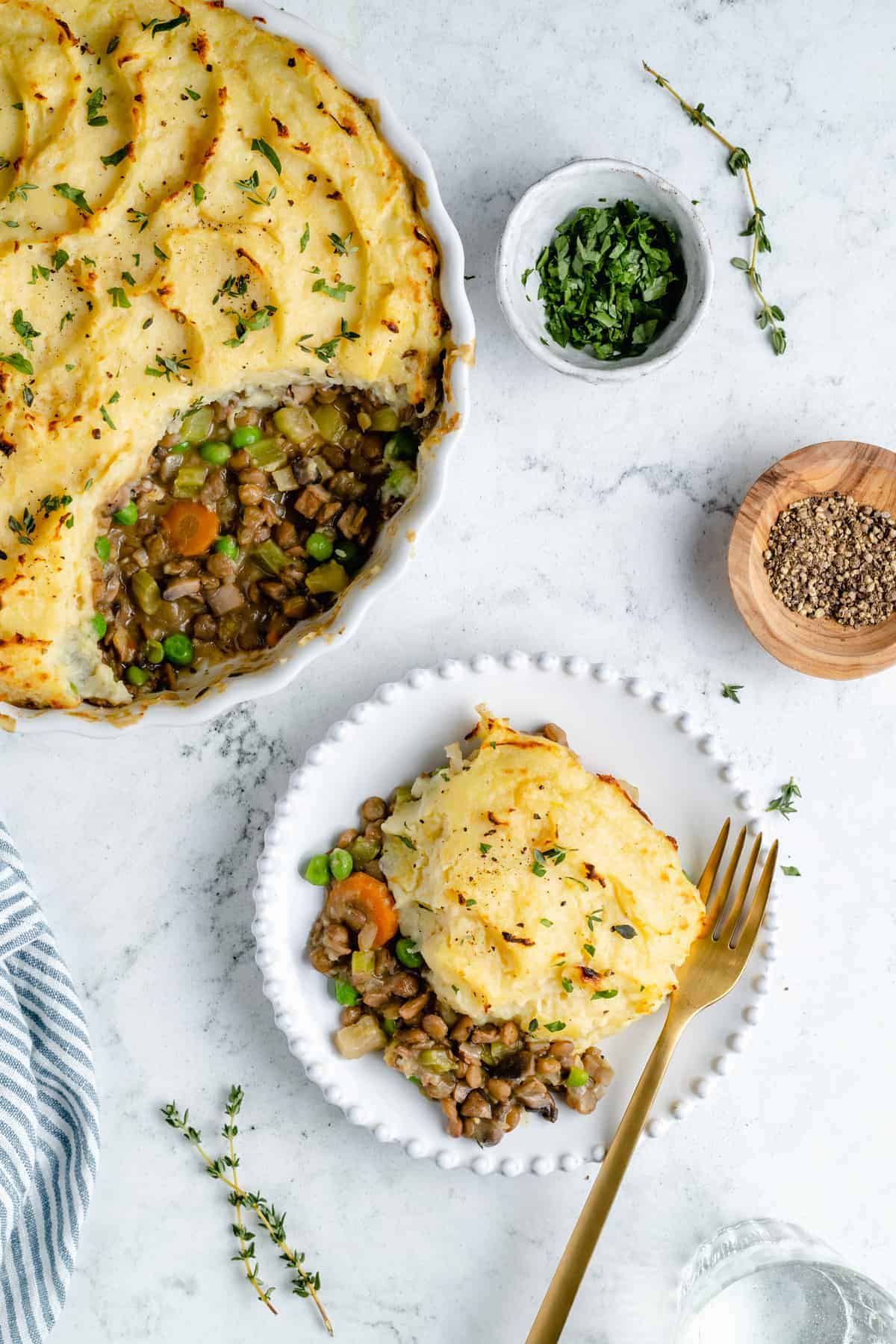 Vegan Shepherd's Pie in dish with one serving removed and plated