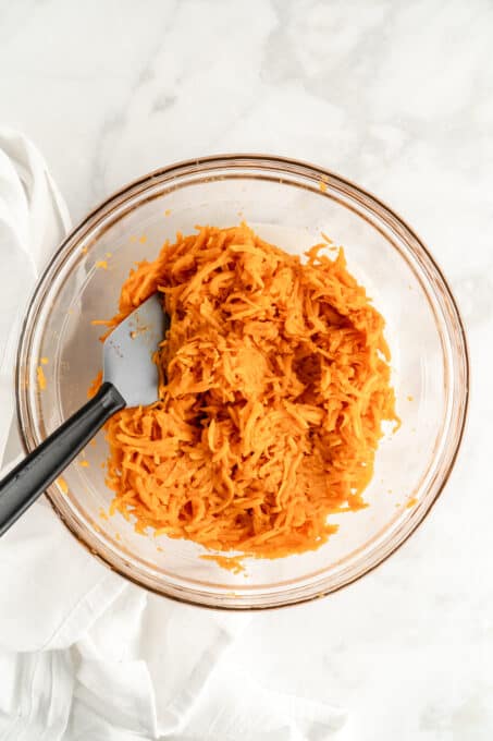 Glass bowl filled with shredded sweet potato