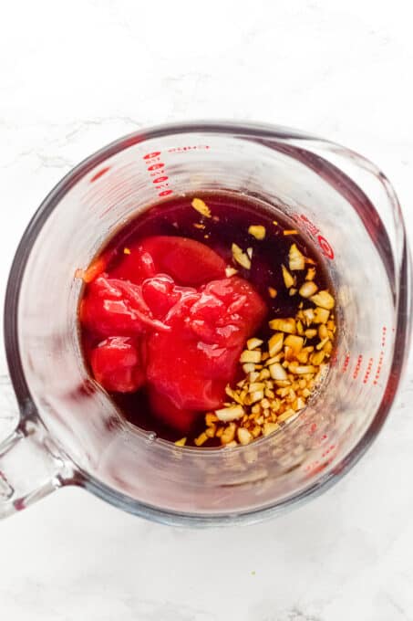 ingredients to make gochujang sauce in a glass measuring cup