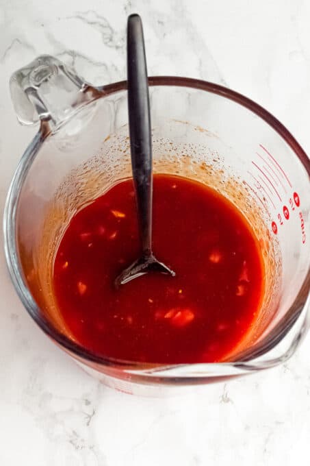 My gochujang tofu rice bowl recipe is a quick, incredibly flavourful make-ahead dish! Perfect for weeknight dinners and meal prep lunches. Gochujang sauce in a measuring cup.