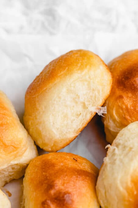 close up of dinner rolls in a baking dish separated