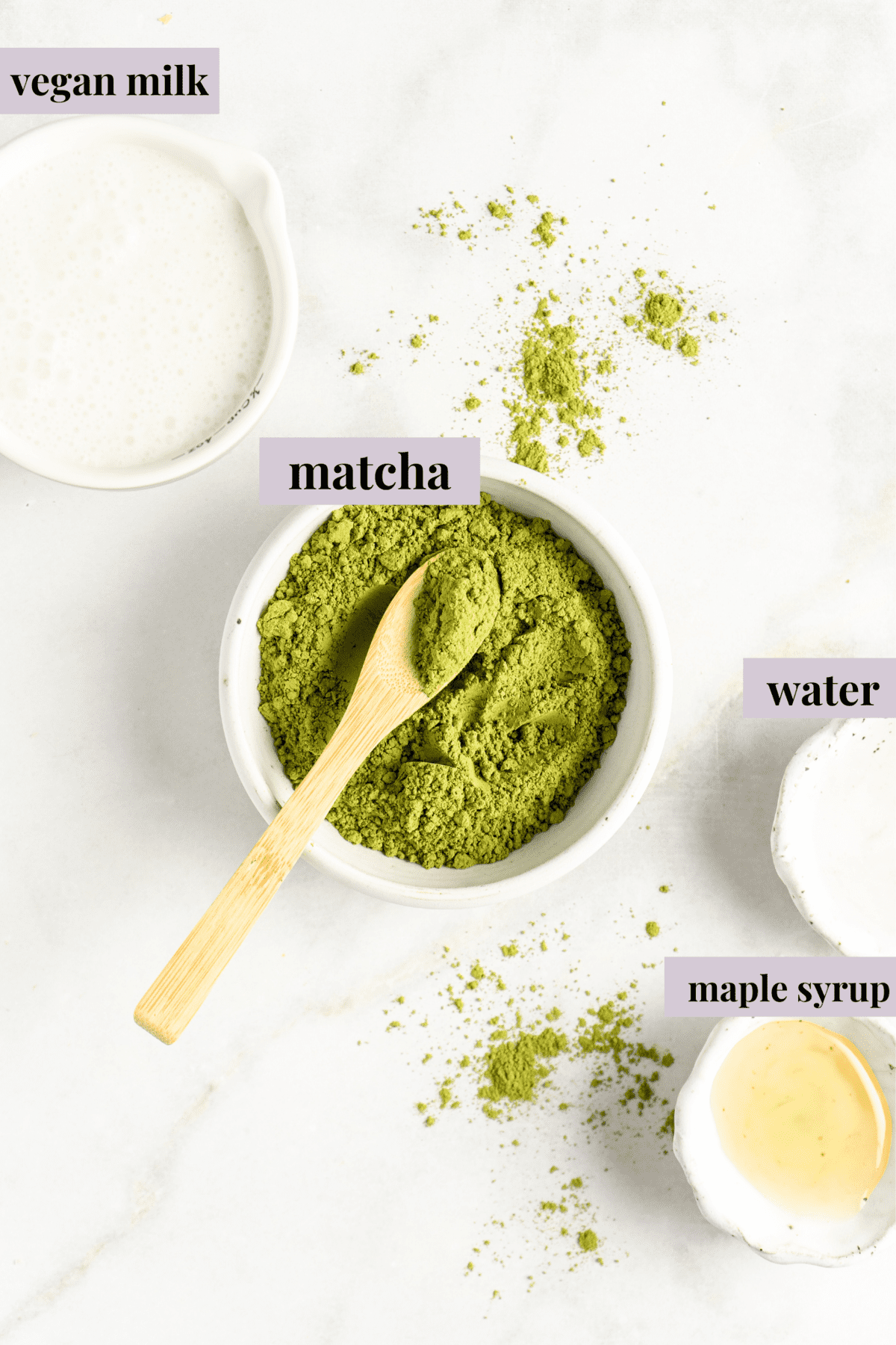 Small bowl of matcha powder with wooden spoon