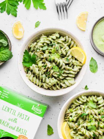 green goddess pasta in two bowls with box of pasta in the corner