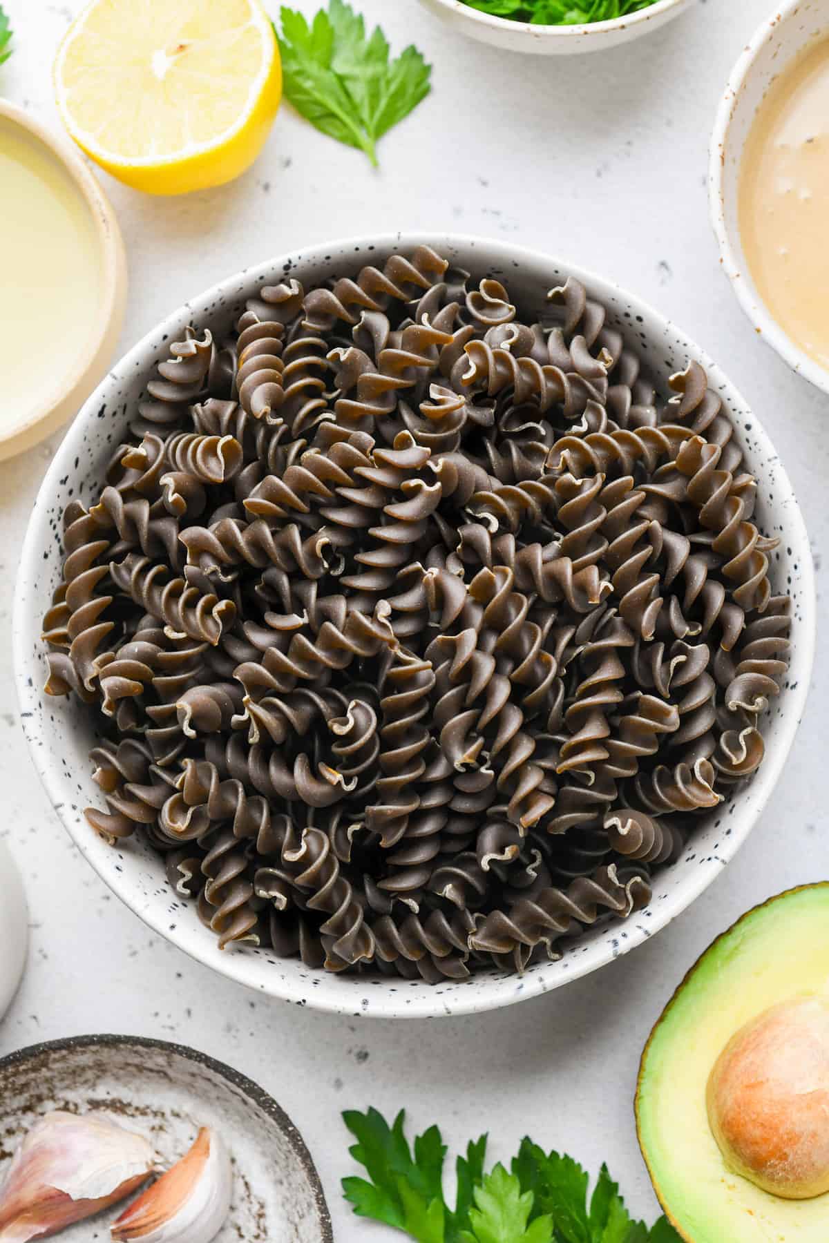 raw uncooked green lentil pasta in a bowl