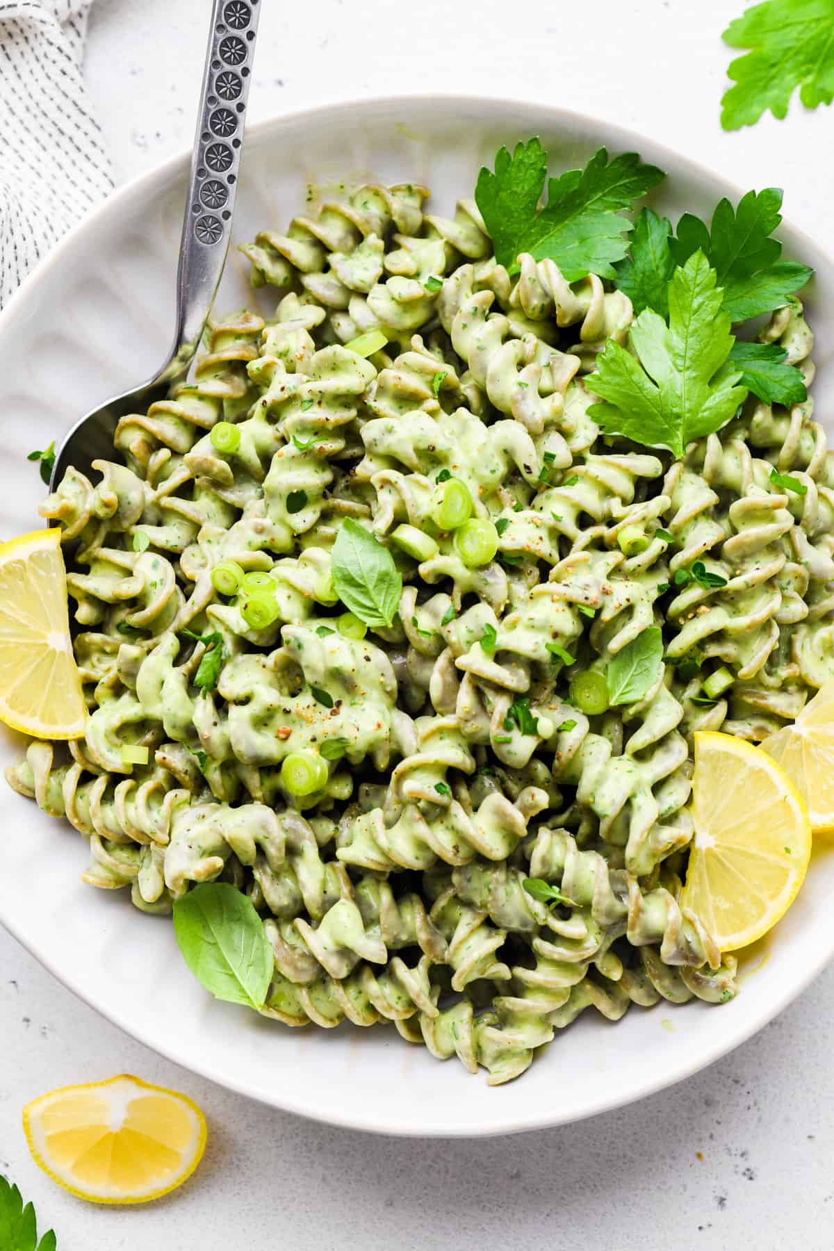 green goddess pasta in a bowl with a spoon in it