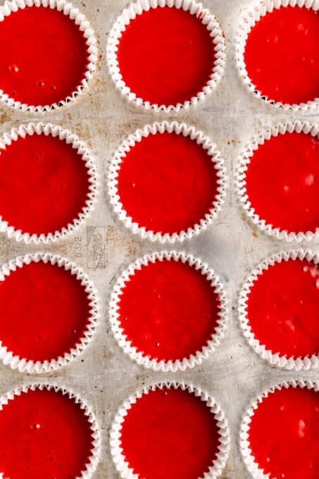 Red velvet cake batter in cupcake wrappers