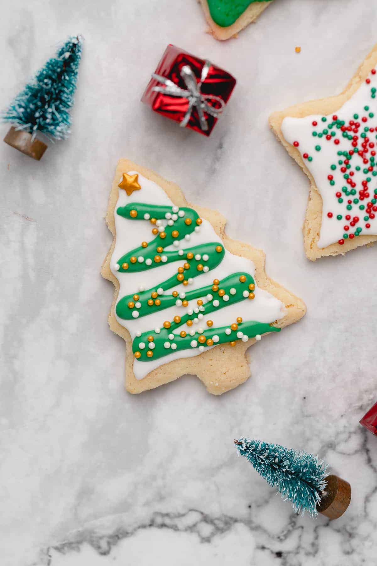 Closeup of Christmas tree cutout sugar cookie with frosting and sprinkles