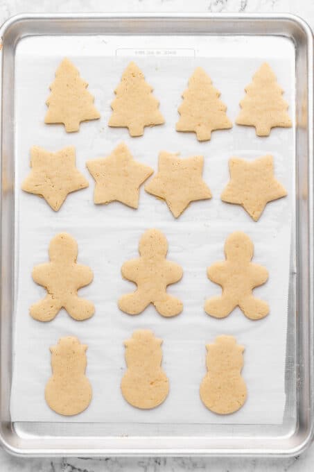 Overhead view of baked sugar cookies on parchment-lined baking sheet