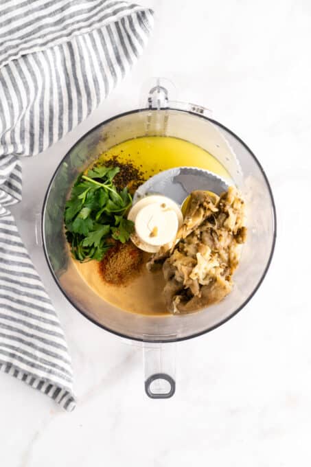 Overhead view of baba ghanoush ingredients in food processor