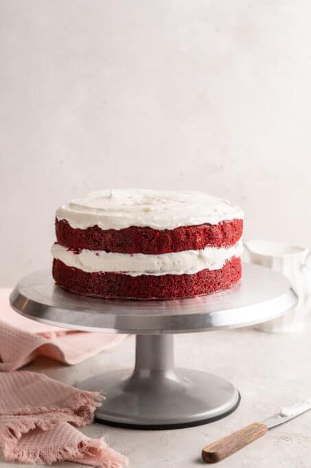 Vegan red velvet cake on cake pedestal