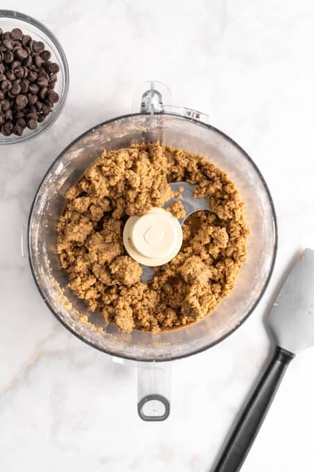 Overhead view of edible cookie dough in food processor