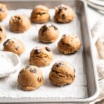 Edible chocolate chip cookie dough on parchment lined baking sheet