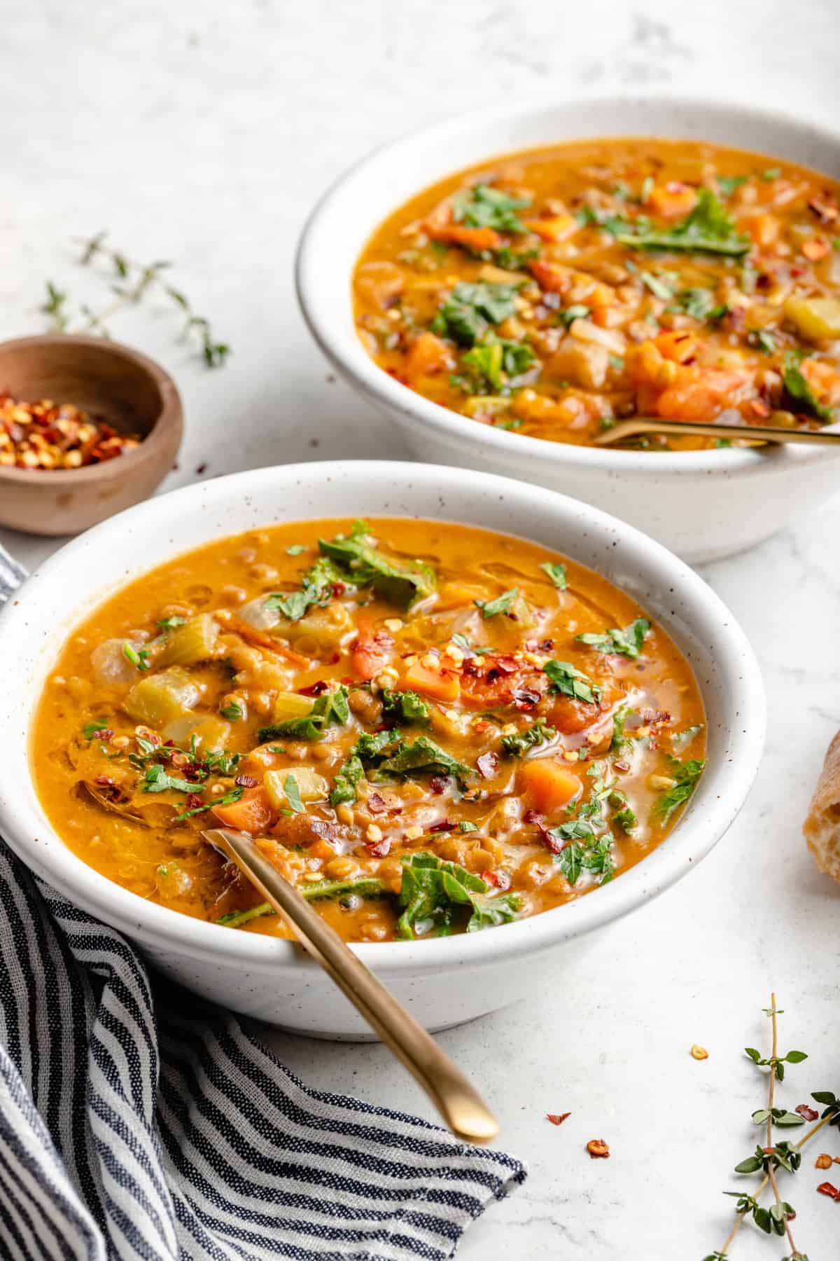 Two white bowls filled with vegan lentil soup