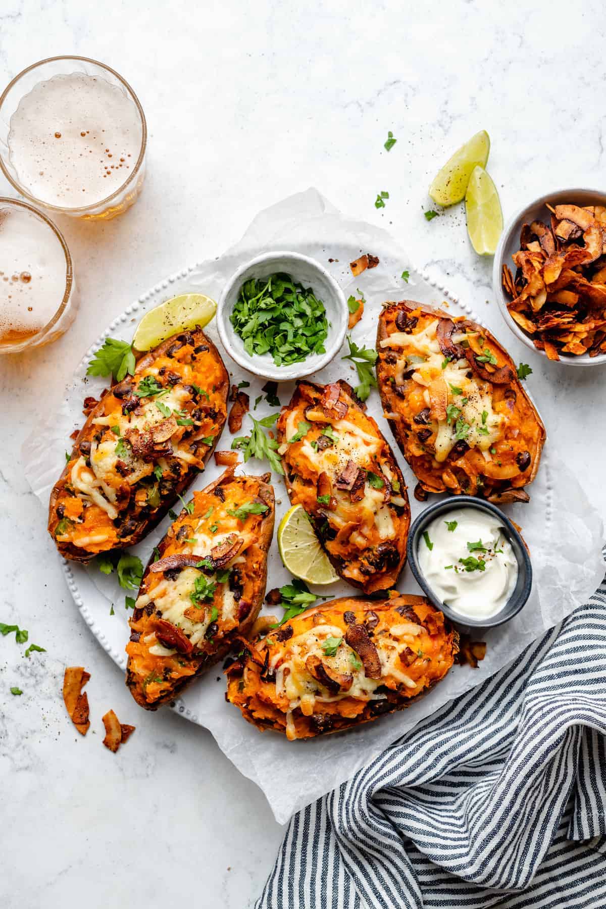 Overhead view of vegan sweet potato skins on plate with garnishes