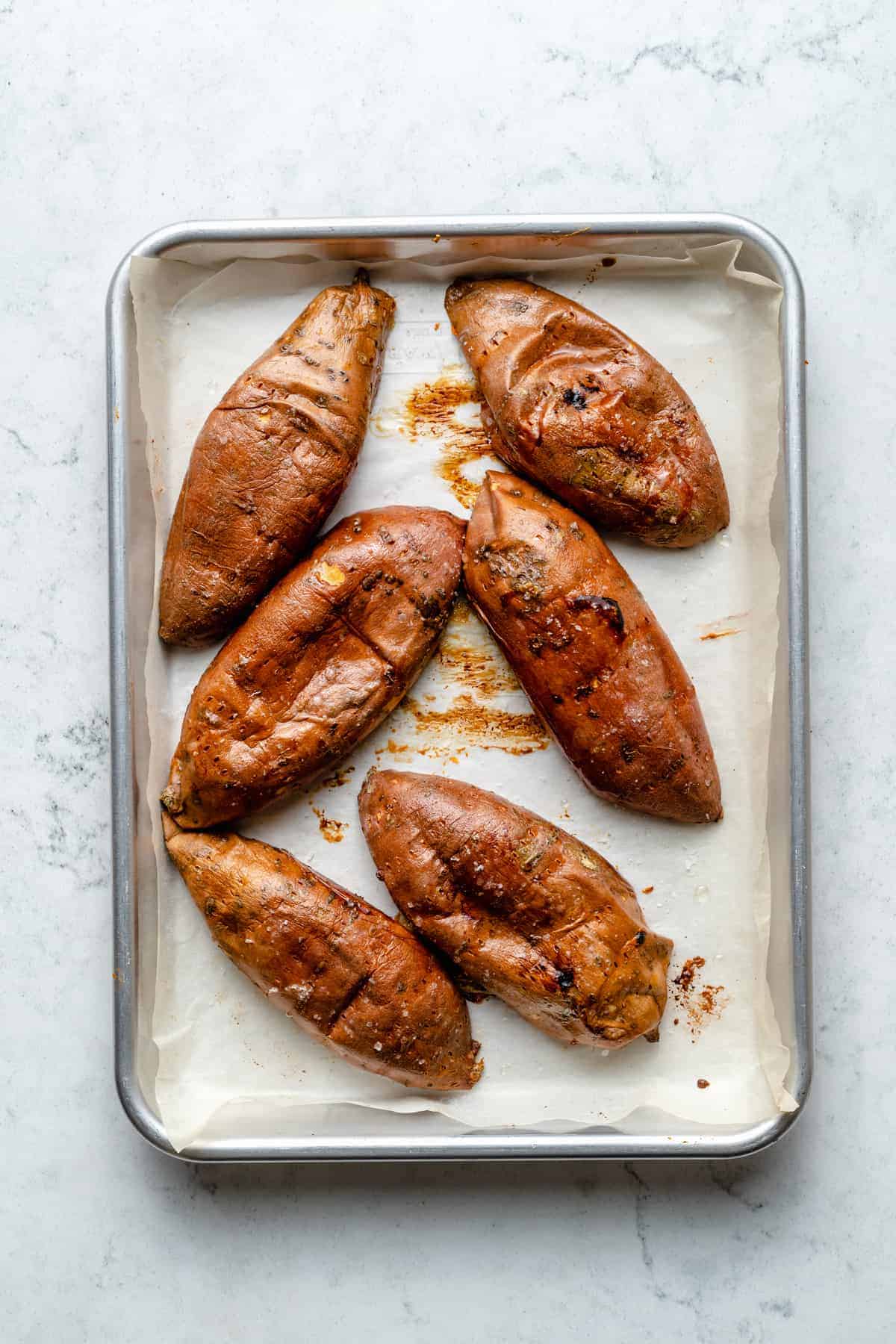 Overhead view of sweet potato skins cut-side-down on baking sheet