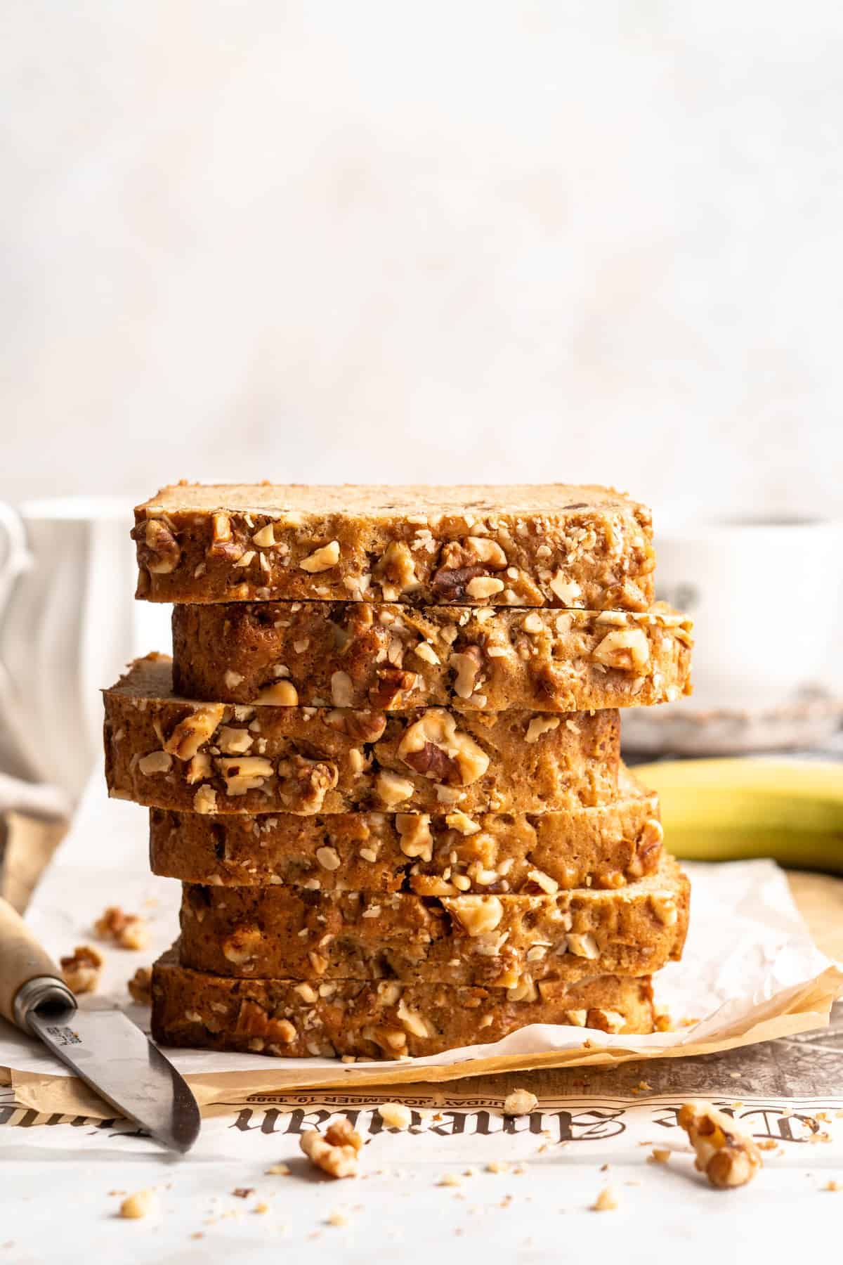 Stacked slices of banana bread set on parchment paper