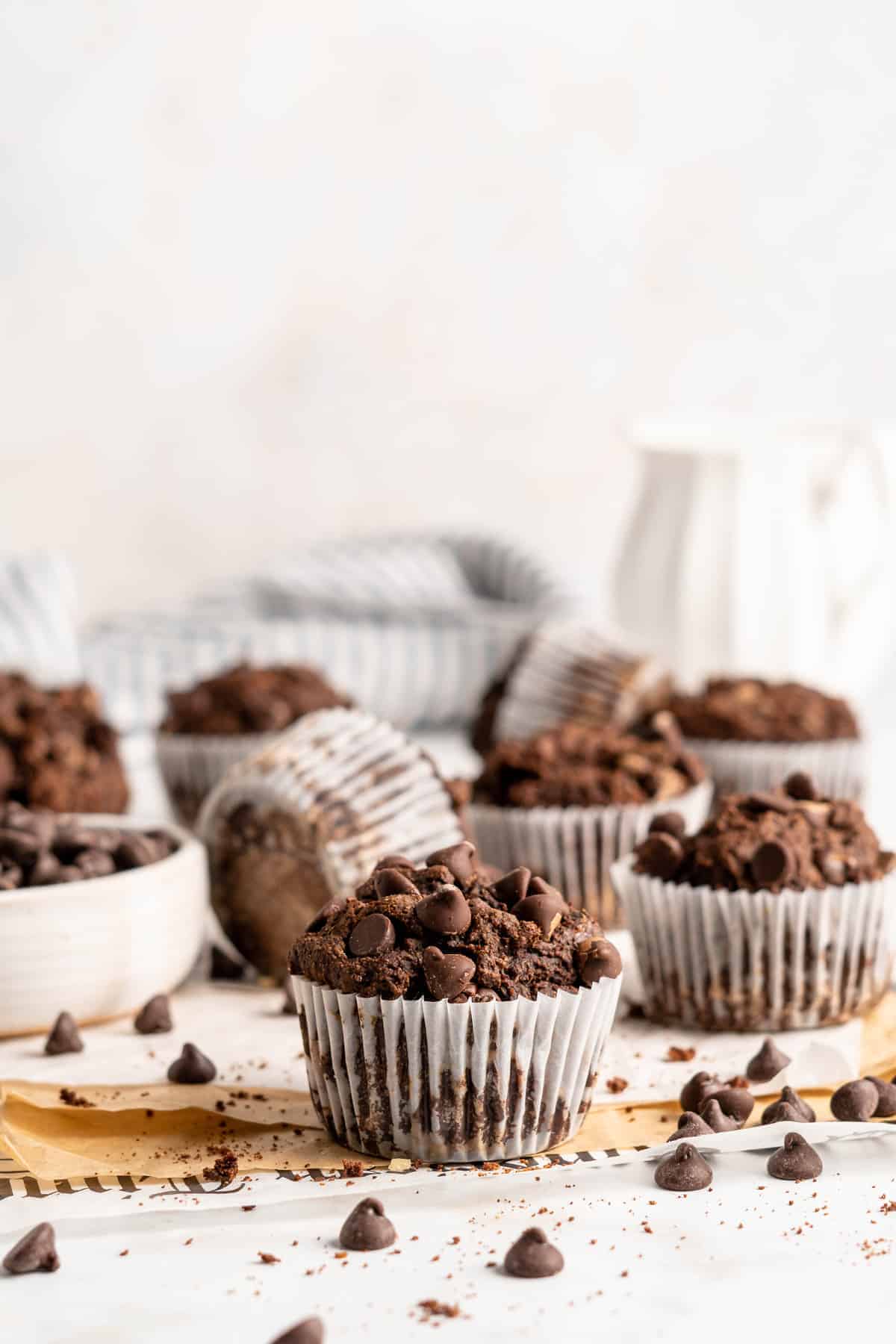 Chocolate Banana Muffins surrounded by chocolate chips