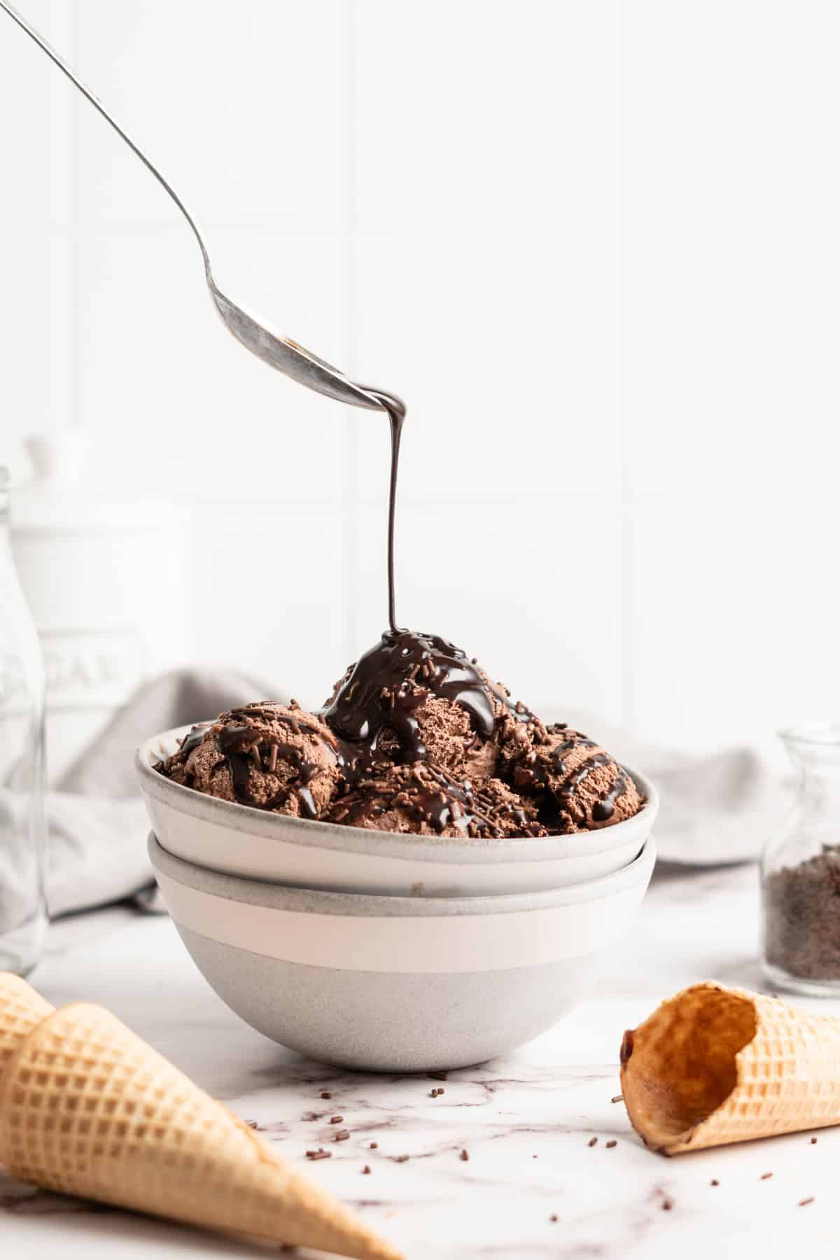 Chocolate syrup drizzled onto bowl of Chocolate Avocado Ice Cream