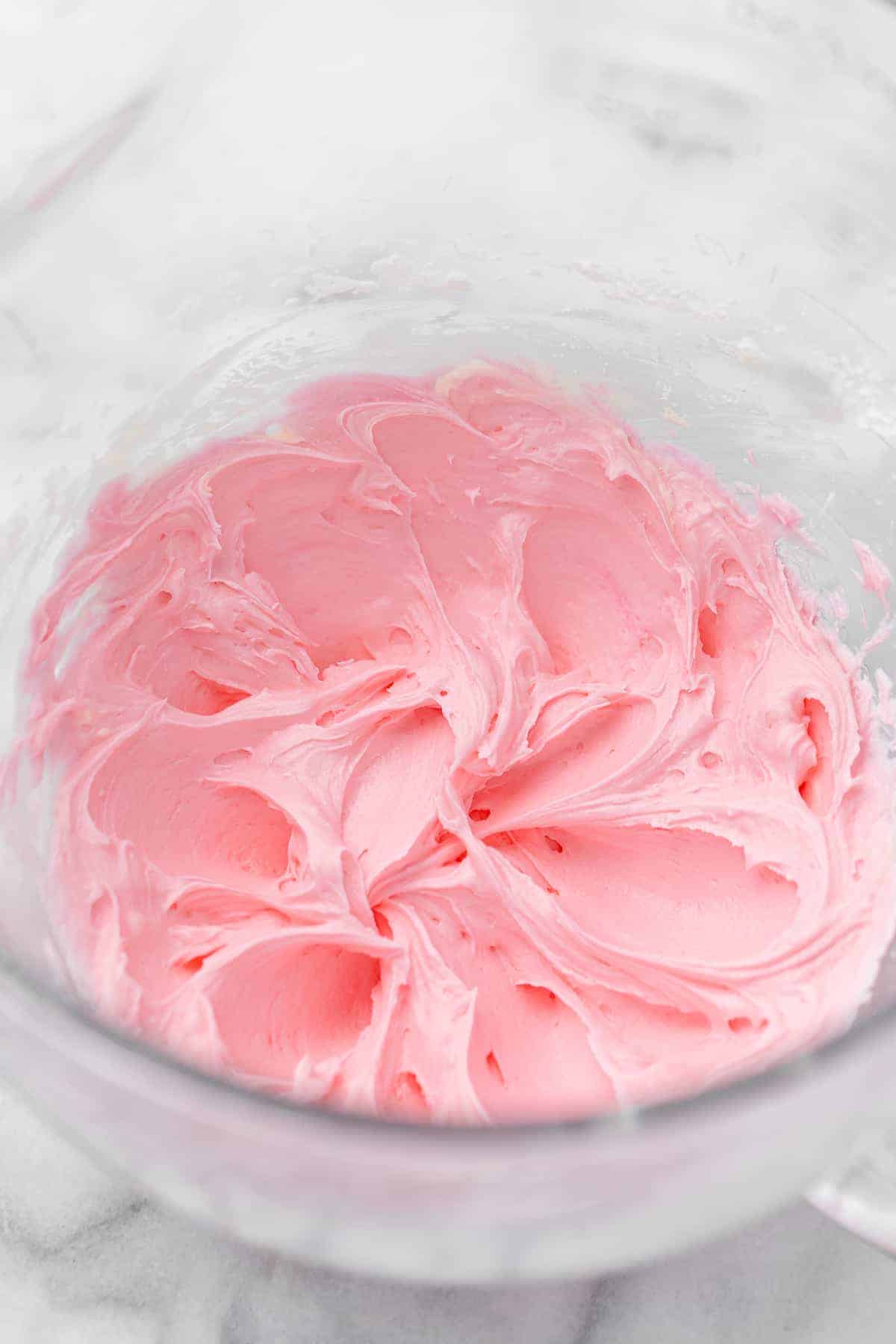 Pink frosting in mixing bowl