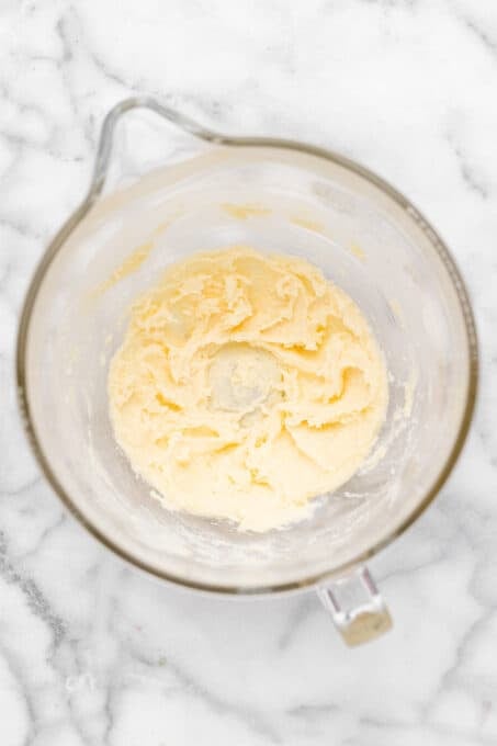 Overhead view of creamed butter and sugar in mixing bowl