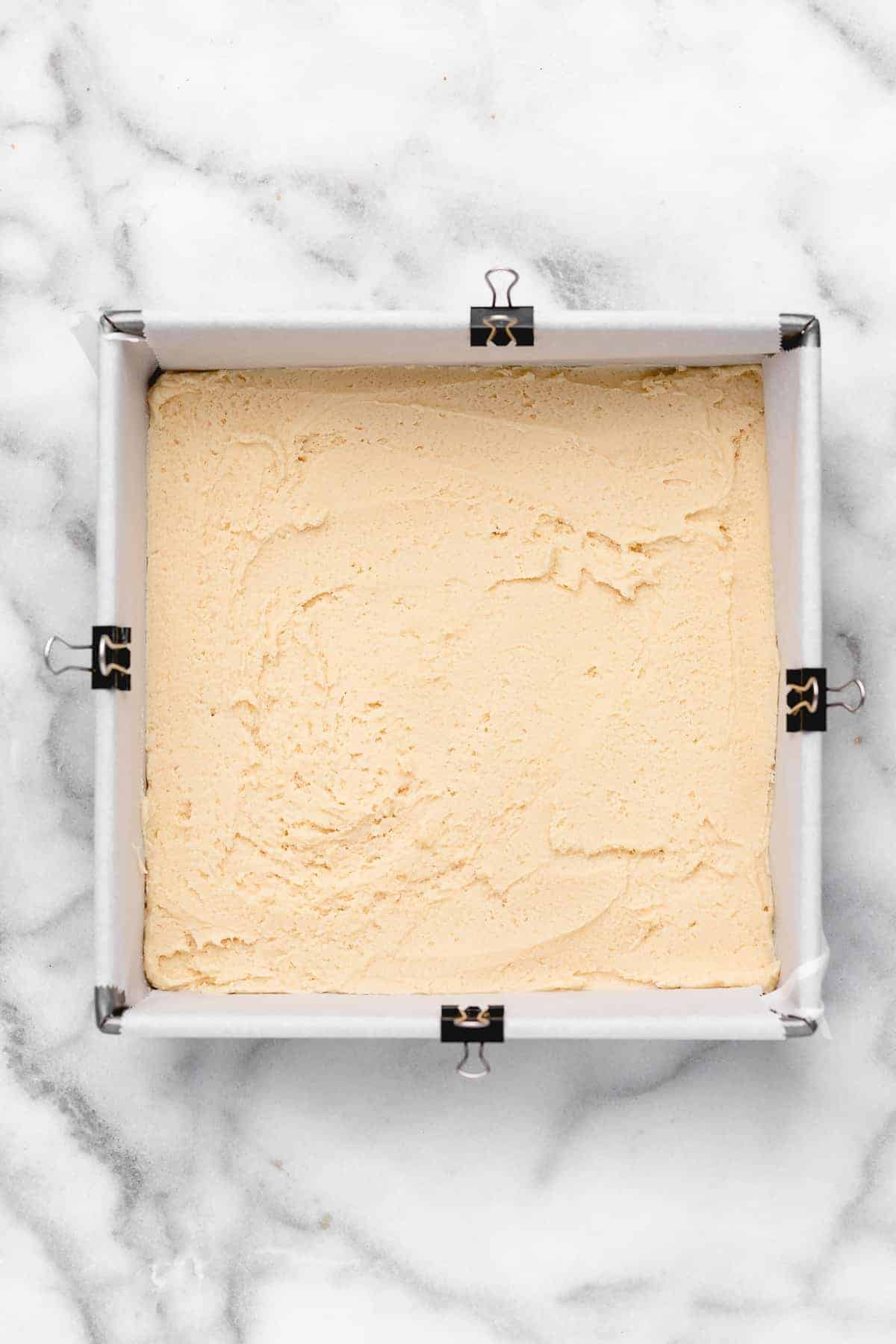Overhead view of sugar cookie dough in square baking pan