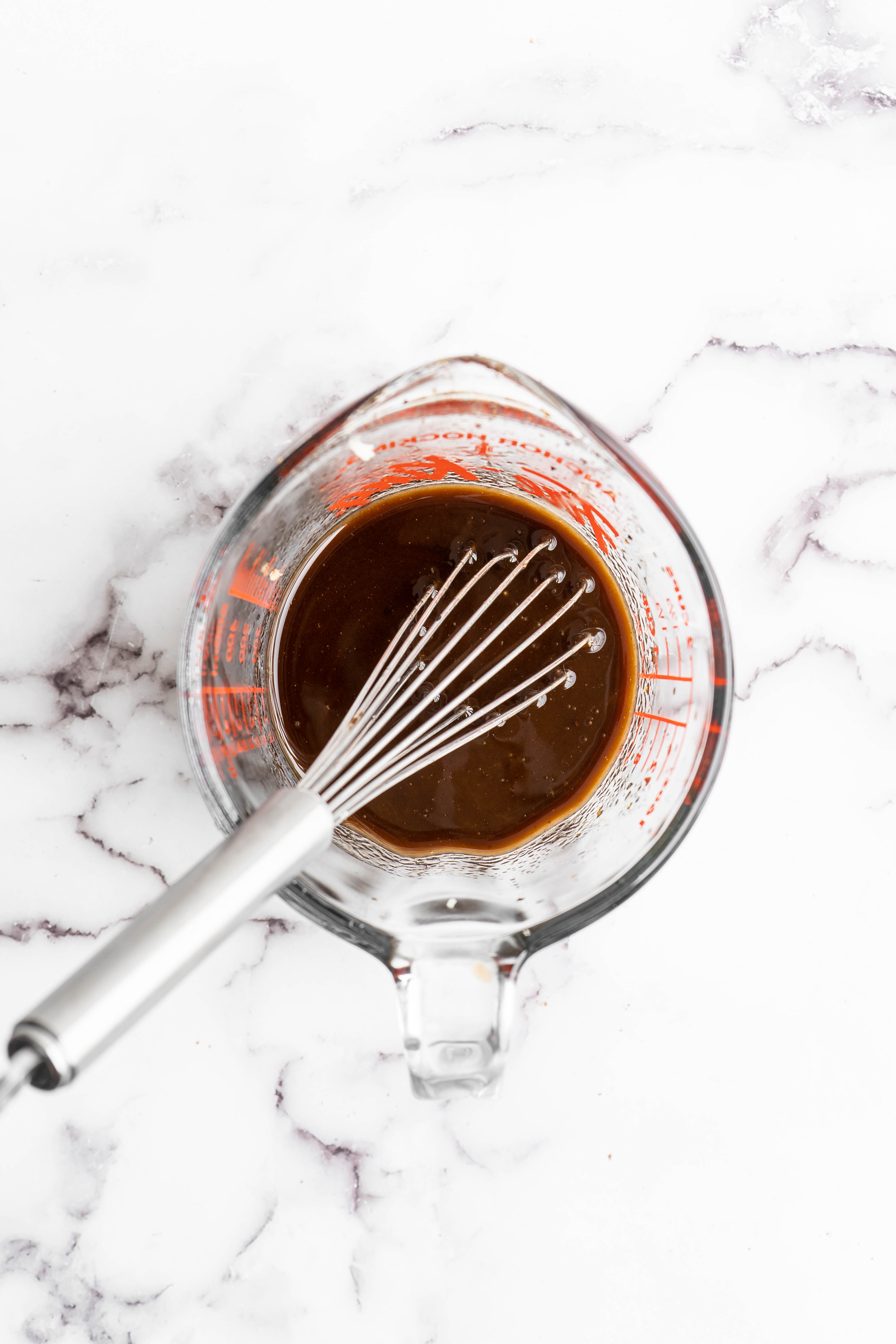 Overhead view of balsamic marinade in measuring cup