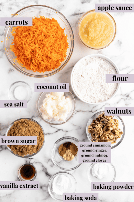 This classic two-layer carrot cake is perfectly spiced, made without dairy or eggs, and frosted with fluffy vegan cream cheese frosting! Overhead view of vegan carrot cake ingredients with labels