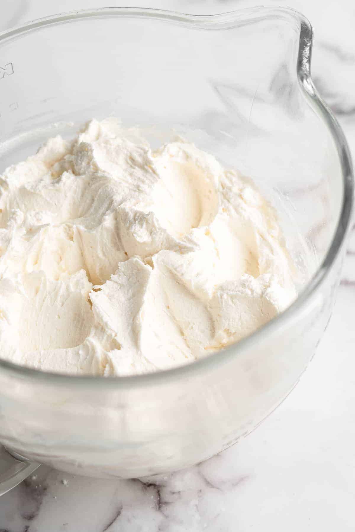 Vegan cream cheese frosting in glass mixing bowl