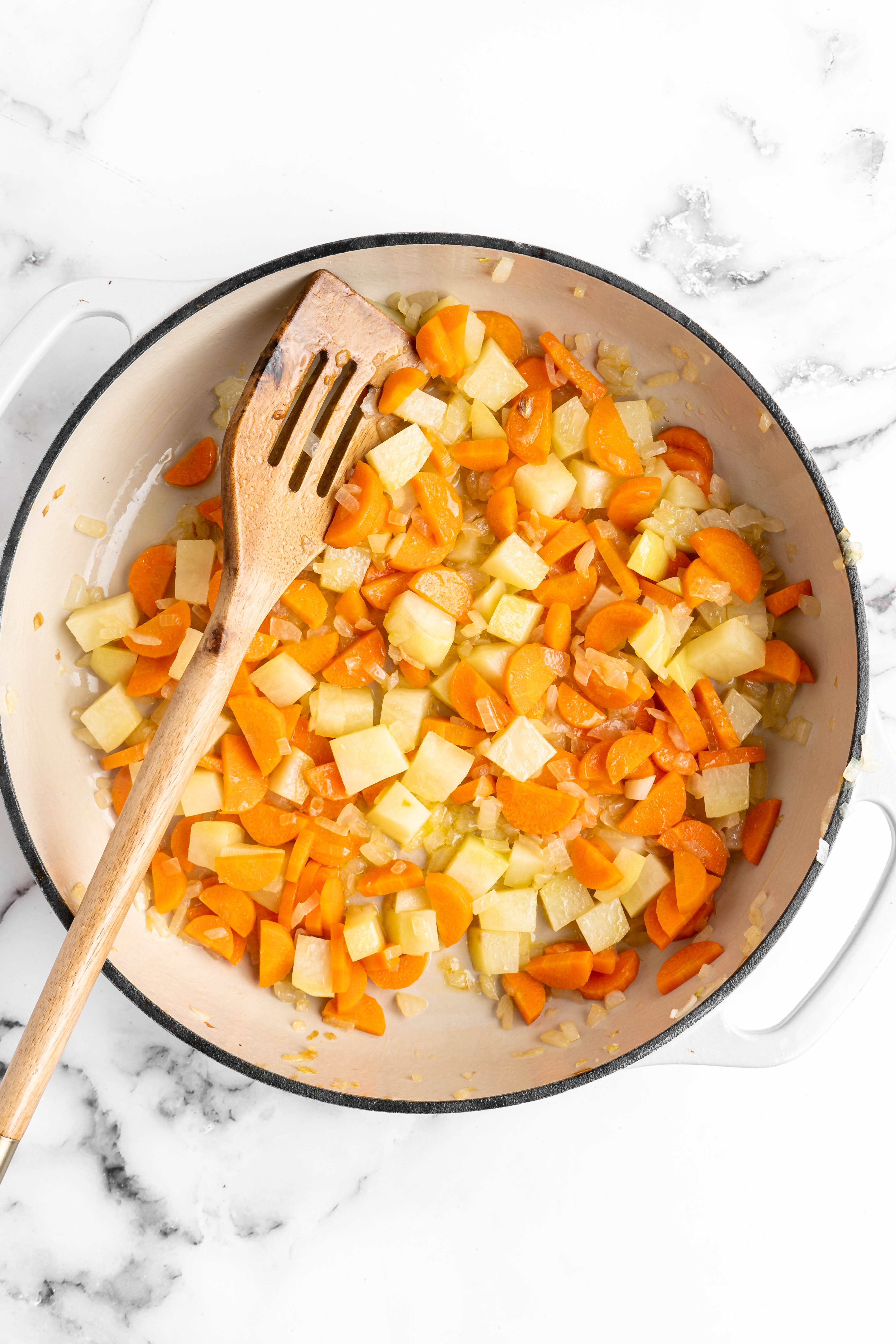Carrots, potatoes, and onions in pan