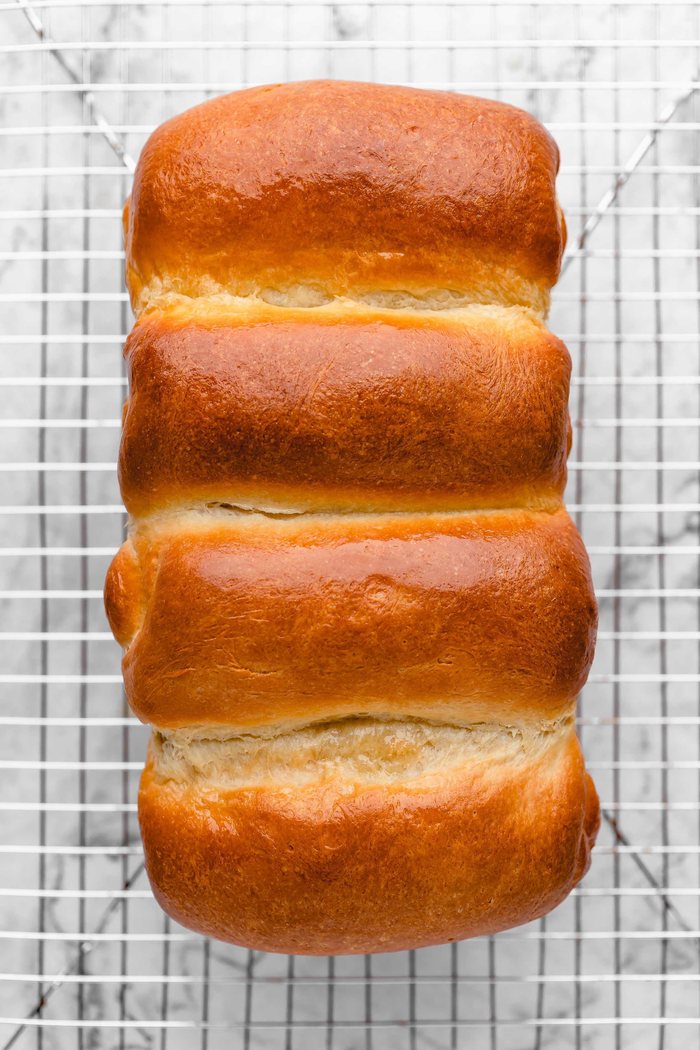 Overhead view of vegan milk bread on cooling rack