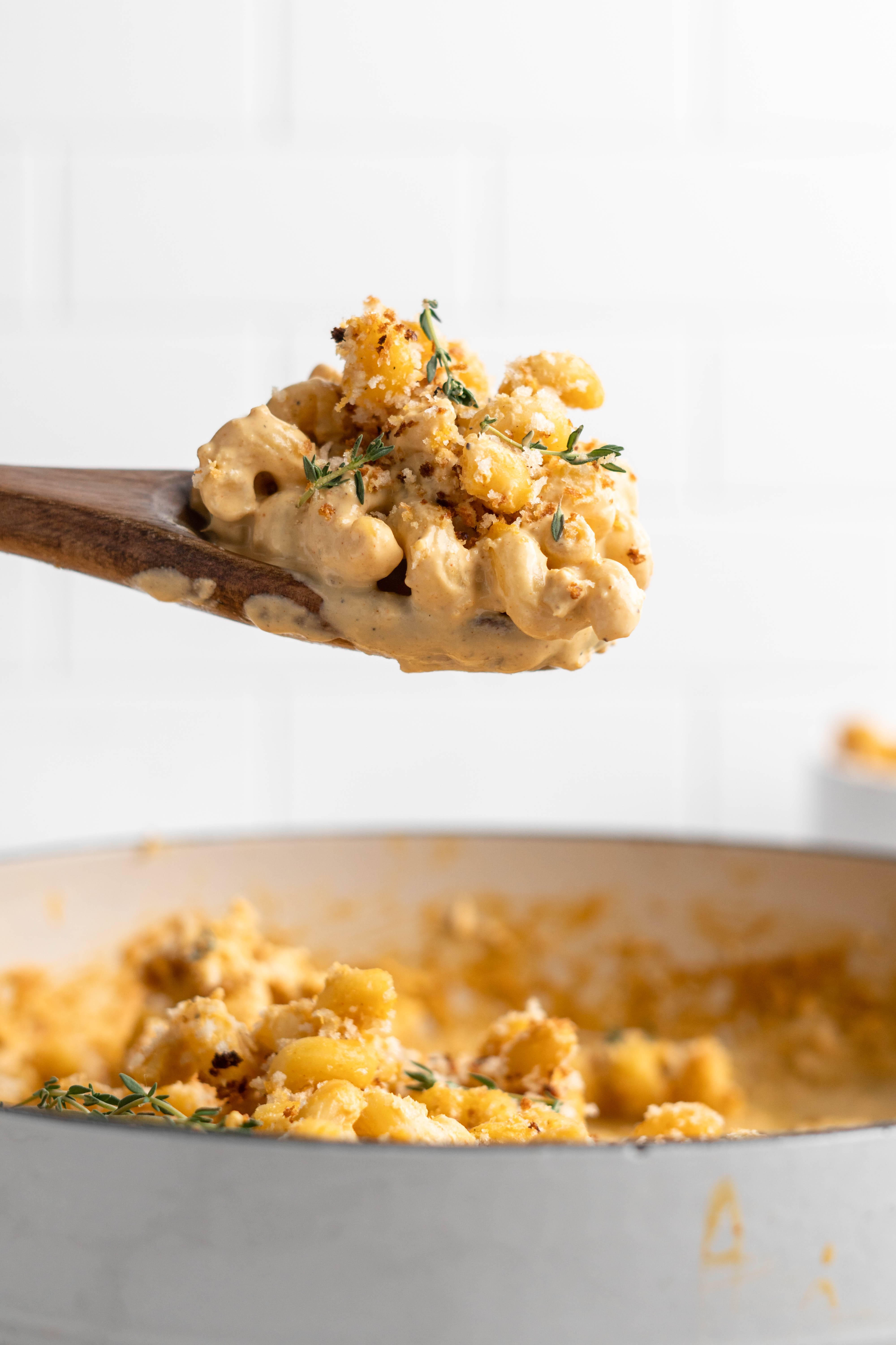 Vegan mac and cheese on wooden spoon